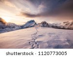 Landscape of snow mountains range with footprint on snowy at sunrise morning