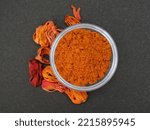 Small photo of Mace Spice powder in a bowl on black background