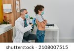 Small photo of Auscultation of lungs and respiratory system. Pediatrician listening to boy's lungs using a stethoscope while consultation at medical center