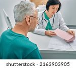 Small photo of Diagnostic heart diseases, heart attacks, and tachycardia in elderly people. Doctor consulting senior man on results of his cardiogram and test
