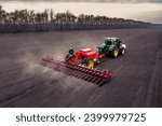 Small photo of Ukraine, Kyiv region, 12.04.2021. Tractor plows the field, plowed land, harvest 2023.