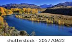Autumn colors on Clutha River, Southern Alps in the background, Otago, New Zealand