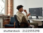 Multiethnic stock trader with glass of water taking capsule of dietary supplements for best mental work. African american trader with glass of water drinks pill while working at home modern office.