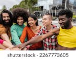 group of diverse friends put their hands together