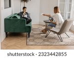 Small photo of Upset young man getting divorced, sitting on couch in counselor's office, touching his face, attending therapy session with obese female psychologist. Therapy for stress and anxiety. mental health