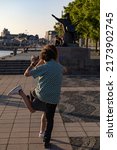 Small photo of Stockholm, Sweden July 1, 2022 Dancers practive tango dancing on Riddarholmen near the water under a landmark statue of Evert Taube, a national troubadour.
