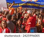 Small photo of Kansas City, MO, USA - February 14, 2024: Travis Kelce, who plays the tight end position for the Kansas City Chiefs NFL football team interacts with many fans during the Super Bowl LVIII Parade