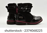 Small photo of Girlie winter black boots shot on white background