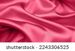 Small photo of Viva Magenta toned red magenta fabric atlas. Close up pink silk satin texture for sewing. Abstract background wallpaper. Twisted folds cloth. Trendy color of the year 2023. Fashion color pattern