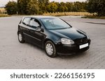 Small photo of Hatchback black modern family car on street outside. Vehicle