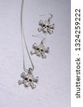 Small photo of closeup of fashionable skull and crossbones necklace set