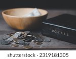 Small photo of One tenth or tithe is basis on which Bible teaches us to donate one tenth of first fruit to God. Coins with Holy Bible. Religion donation and funding. Giving money, the symbol of Christianity donation