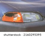Small photo of A broken right turn signal of a passenger car. Accident a car accident causes damage to the housing and cover of the lamp (lamp, incandescent lamp). It needs to be repaired or repaired. Car crash.