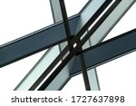Small photo of Close-up photo of industrial or office building fragment. Load-bearing structure. Junction or nodal point of metal framework. Abstract modern architecture or construction industry background.