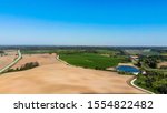 Farmers field. Green farmers field.
shot from above, from drone. Field and forest. Beautiful top view of plowed and sown fields. Aerial panorama drone view of typical agricultural landscape.