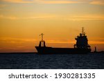A Silhouette Of A Cargo Ship At ...