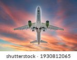 Commercial airplane jetliner flying above dramatic clouds in beautiful sunset light. flight travel transport airline background concept. Airplane in the sunset sky