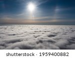 sunrise on blue sky. Blue sky with some clouds. View over the clouds.