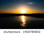 Small photo of Panorama Of Autumn River Landscape In Belarus Or European Part Of Russia At Sunset. Sun Shine Over Blue Water Lake Or River At Sunrise. Nature At Sunny Morning. Woods With Orange Foliage On Riverside