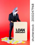 Small photo of Businessman with a shark head as loan shark holding a wooden board written as Loan Agreement and standing on dollars. Modified generic ball-jointed doll.