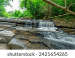 Small photo of Waterfall called Tat Yai Waterfall with rock layer and green forest background in local area called Nam Nao District, Phetchabun, Thailand.