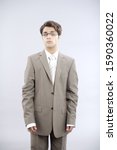 Small photo of Teenage boy in baggy business suit