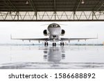 Pilots in private jet in hangar