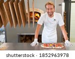 Smiling Chef Preparing A Pizza...
