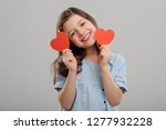 Small photo of Young girl received her valentines, heart-shaped greeting cards. Prettiest girl in the school. Heartthrob concept.