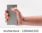 hand holding a power bank on... | Shutterstock . vector #1283662102