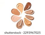 Small photo of Make up foundation smears, different skin tones. cream foundation tonal smudges on white background. Texture of makeup foundation.