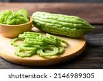 Sliced bitter melon or bitter gourd on wooden board prepare for cooking