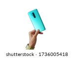 Man hand is holding the newest mint smartphone with triple-camera isolated on white background 
