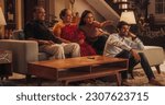 Small photo of Portrait of Happy Indian Family Enjoying Movie Playing on TV at Home Together. Parents and Young Adult Children Share Love for Cinema, watching Favourite Streaming Service TV Shows.