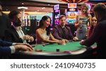 Small photo of Group of Diverse Poker Players Sitting at a Table as the Croupier Deals the Playing Cards in a Modern Casino. An Intense Round of a Gambling on a Championship, People do the Betting.