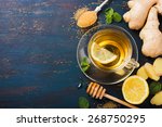 Cup of Ginger tea with lemon and honey on dark blue background, top view