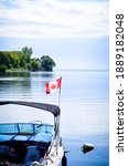 Canadian Flag On Boat At Lake...