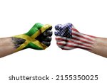 Two hands punch to each others on white background. Country flags painted fists, conflict crisis concept between jamaica and usa