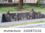 Small photo of Zanzibar, Tanzania -12.01.2021: Zanibar slave market monument. Slaves chained up in a pit ready to be sold. Historical horror place where slaves were bought and sold and then shipped to Asia.