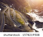 Sunrise at a mountain road in Italy. Stelvio pass, an epic driving road.