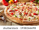 Small photo of Pizza restaurant menu - Meat Pizza on parchment, topped off with meat hot sausage and pepperoni slice. Wooden table with pizza ingredients. Sunlight with harsh shadow. Rustic, natural style food