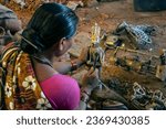 Small photo of Kondagaon,Chhattisgarh,India 03.05.2013. A tribal woman Dhokra artist busy in making metal craft.Tribes like 'Ghadwas' of Bastar and 'Jharas' of Raigarh practice this art form.