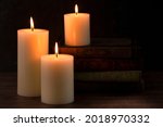 Three Pillar Candles Lit In A...