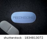 Small photo of Prednisone tablet drug close up Glucocorticoid medication used to suppress the immune system in asthma, COPD, rheumatologic diseases