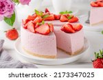 No bake cheesecake with fresh strawberries on a white wooden background. Summer dessert. Selective focus. Copy space