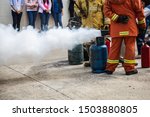 Small photo of Firemen using extinguisher and water for fight fire during firef