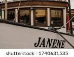 Small photo of Seattle, WA USA. 5.23.2020 Fisherman's Terminal. A Commercial fishing boat moored to the dock with window reflection. Janene