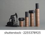 Small photo of Crude oil tank on stack coin as price chart graph rising up and pump jack on grey background. World petroleum and energy industry or trading commodity investment, crude oil and gas price increase.