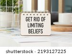 Small photo of Get Rid Of Limiting Beliefs. text on wood table, on white paper.