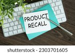 Small photo of Product Recall text on sticky with keyboard, pen glasses on grey background